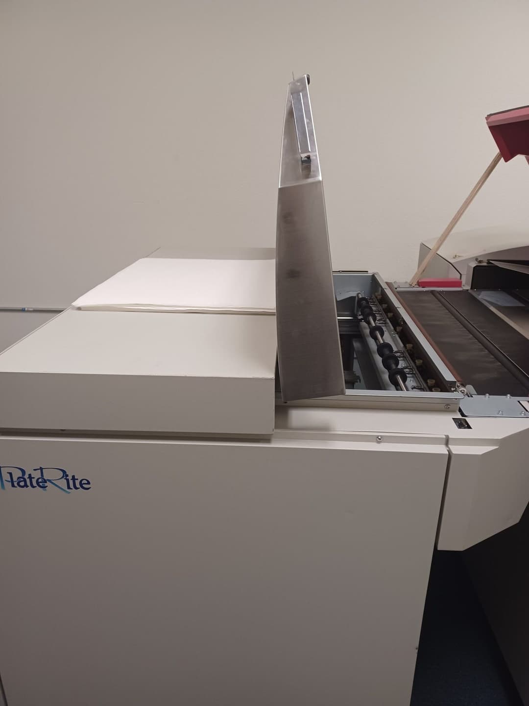 HateRite printing machine with open lid, showcasing its printing features and design.