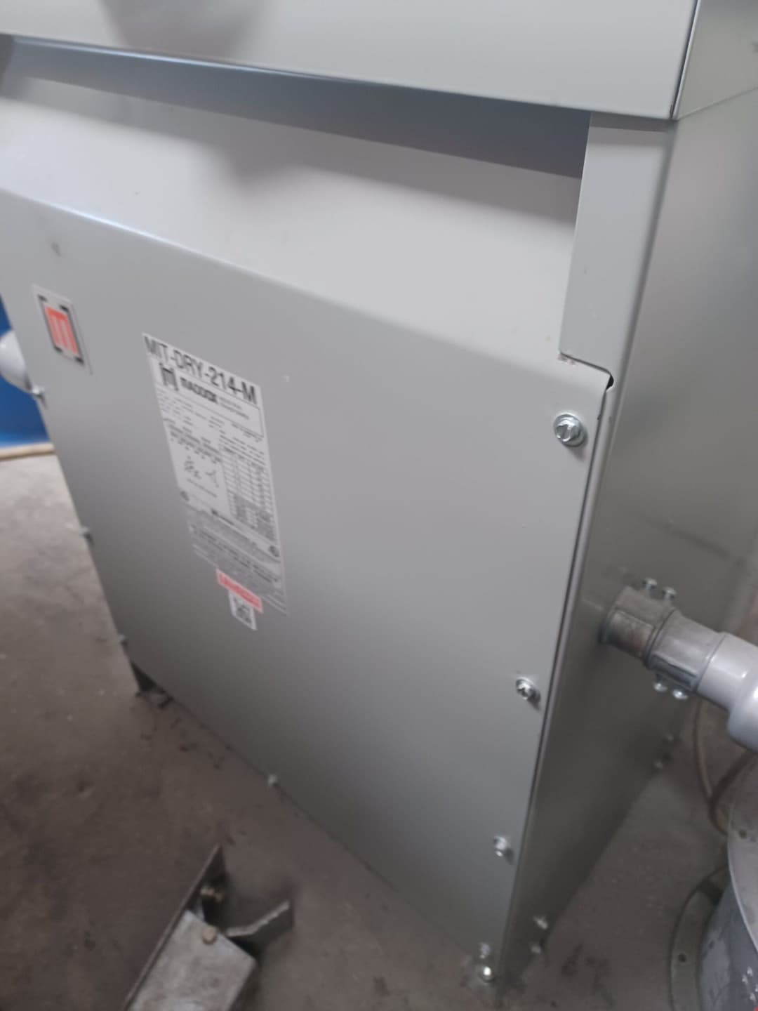 Gray industrial dehumidifier model MLT-DRY-214M in a maintenance area.